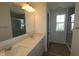 Bright bathroom featuring double sinks, a large mirror, and a glass-enclosed shower, creating a spa-like experience at 10126 Redwood Peak Ln, Indianapolis, IN 46259