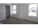 Carpeted bedroom featuring two windows, a closet, and neutral decor, offering a blank canvas for personalization at 10126 Redwood Peak Ln, Indianapolis, IN 46259