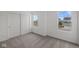 Comfortable bedroom featuring plush carpet, windows, and a closet with sliding doors at 10126 Redwood Peak Ln, Indianapolis, IN 46259