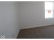 Bare bedroom with neutral carpet and a window providing natural light, creating a versatile and comfortable space at 10126 Redwood Peak Ln, Indianapolis, IN 46259