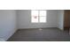 Spacious bedroom with neutral carpet, white walls, and a large window, creating a bright and airy atmosphere at 10126 Redwood Peak Ln, Indianapolis, IN 46259