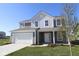 Charming two-story home featuring gray siding, white trim, an attached two-car garage and a well-maintained front lawn at 10126 Redwood Peak Ln, Indianapolis, IN 46259