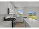 Modern white kitchen features quartz counters, stainless appliances, and ample natural light at 10126 Redwood Peak Ln, Indianapolis, IN 46259