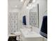 Stylish bathroom showcasing a vanity, framed mirror, shower, and black tile flooring at 1021 Harlan St, Indianapolis, IN 46203