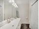 Modern bathroom with double sinks, a large mirror, and a tiled shower area at 1021 Harlan St, Indianapolis, IN 46203