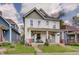 Charming two-story home with a well-maintained lawn and inviting front porch, perfect for relaxing and enjoying the neighborhood at 1021 Harlan St, Indianapolis, IN 46203