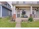 Welcoming front porch featuring vibrant potted plants, offering a cozy and inviting entrance to this charming home at 1021 Harlan St, Indianapolis, IN 46203