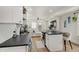 Well-lit kitchen featuring stainless appliances, and an island, seamlessly flowing into the living area with stylish bar stools at 1021 Harlan St, Indianapolis, IN 46203