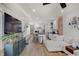 Bright living room featuring hardwood floors, a modern ceiling fan, and an open layout with seamless kitchen integration at 1021 Harlan St, Indianapolis, IN 46203