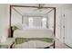 Bright main bedroom featuring a four-poster bed, ceiling fan, and white walls at 1021 Harlan St, Indianapolis, IN 46203