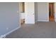 Spacious bedroom with neutral carpeting, gray walls, and entry to bathroom at 10544 Maidenhair Dr, Indianapolis, IN 46239