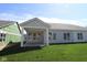 Rear exterior view of home featuring a covered patio with large windows at 10544 Maidenhair Dr, Indianapolis, IN 46239