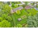 Expansive backyard featuring a well-manicured lawn and a small storage shed, surrounded by mature trees at 10559 Rolling Springs Dr, Indianapolis, IN 46234