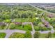Aerial view of a home with a large, green yard, mature trees, and nearby highway access at 10559 Rolling Springs Dr, Indianapolis, IN 46234