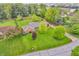 Aerial view of a beautiful home with a well-manicured lawn and mature trees at 10559 Rolling Springs Dr, Indianapolis, IN 46234