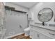 Chic bathroom featuring white vanity, granite countertop, shiplap accent wall, and modern fixtures at 10559 Rolling Springs Dr, Indianapolis, IN 46234