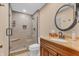 Bathroom featuring a walk-in shower, tile surround, and vanity with sink at 10559 Rolling Springs Dr, Indianapolis, IN 46234