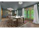 Elegant dining room features a modern table and chairs, soft lighting, and views of the outdoors at 10559 Rolling Springs Dr, Indianapolis, IN 46234
