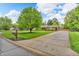 Brick home boasts mature trees, an expansive yard, and a long driveway leading to a charming residence at 10559 Rolling Springs Dr, Indianapolis, IN 46234