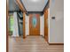 Inviting foyer showcasing wood trim, decorative front door, and wood laminate flooring at 10559 Rolling Springs Dr, Indianapolis, IN 46234