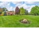 Well-maintained brick home with a spacious front yard and mature trees creating a serene setting at 10559 Rolling Springs Dr, Indianapolis, IN 46234