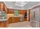 Kitchen featuring wood cabinets, stainless steel appliances, and a large sink at 10559 Rolling Springs Dr, Indianapolis, IN 46234