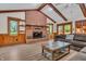 Living room featuring wood floors and a brick fireplace flanked by built-in shelving at 10559 Rolling Springs Dr, Indianapolis, IN 46234