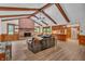 Spacious living room featuring exposed beams, brick fireplace, and wood floors at 10559 Rolling Springs Dr, Indianapolis, IN 46234