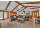 Cozy living room with exposed beams, wood floors, and access to the outdoors at 10559 Rolling Springs Dr, Indianapolis, IN 46234