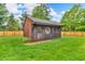 Charming wooden shed with shingled roof and decorative accents, nestled in a green lawn at 10559 Rolling Springs Dr, Indianapolis, IN 46234