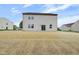 View of the back of a two-story home with a large backyard, ready for landscaping at 1147 Kelsneland Dr, Avon, IN 46123