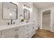 Stylish bathroom with dual sinks, quartz countertop, black fixtures, and a view into the walk-in closet at 1147 Kelsneland Dr, Avon, IN 46123