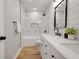 Modern bathroom with marble tile, soaking tub, and dual sink vanity with black hardware at 1147 Kelsneland Dr, Avon, IN 46123