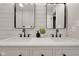Bathroom featuring a dual vanity with undermount sinks, black faucets, and framed mirrors at 1147 Kelsneland Dr, Avon, IN 46123