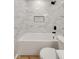 Bathroom with white marble-style tiled shower, soaking tub, and a modern black showerhead at 1147 Kelsneland Dr, Avon, IN 46123