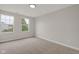 A minimalist bedroom with neutral carpet, walls, and ample natural light from two large windows at 1147 Kelsneland Dr, Avon, IN 46123