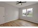 Cozy bedroom with wood-look floors, a ceiling fan, and bright double windows at 1147 Kelsneland Dr, Avon, IN 46123