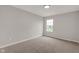 A bedroom filled with neutral colors, carpet flooring, and a window providing natural light at 1147 Kelsneland Dr, Avon, IN 46123