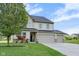 Charming two-story home boasts a three car garage, well-maintained lawn, and mature trees at 1147 Kelsneland Dr, Avon, IN 46123