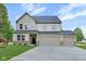 Charming two-story home with a three car garage and well-manicured lawn at 1147 Kelsneland Dr, Avon, IN 46123