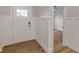 Bright foyer showcasing white trim, a modern front door, and wood-look floors at 1147 Kelsneland Dr, Avon, IN 46123