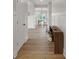 Hallway with wood floors leads to a dining area with natural light at 1147 Kelsneland Dr, Avon, IN 46123