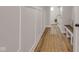 Hallway with attractive wood flooring, decorative rug, paneled walls, and a built-in bench with pillows at 1147 Kelsneland Dr, Avon, IN 46123