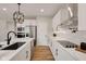 Open kitchen featuring an island with sink, white cabinetry, stainless appliances, and a wood-look floor at 1147 Kelsneland Dr, Avon, IN 46123