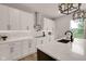 Bright kitchen showcasing white cabinetry, stainless steel range hood, and an island with waterfall countertop at 1147 Kelsneland Dr, Avon, IN 46123