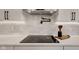 Close-up of a modern cooktop with white countertop and backsplash, as well as stylish accessories at 1147 Kelsneland Dr, Avon, IN 46123