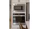 Stainless steel microwave and oven are built into white kitchen cabinetry at 1147 Kelsneland Dr, Avon, IN 46123