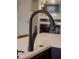 Close up of modern kitchen sink and faucet, with white countertops and updated hardware at 1147 Kelsneland Dr, Avon, IN 46123