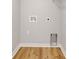 New laundry area featuring gray walls, wood-style flooring, plus hookups for washer and dryer at 1147 Kelsneland Dr, Avon, IN 46123