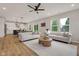 Open concept living room flows into the kitchen, with hardwood floors and modern decor at 1147 Kelsneland Dr, Avon, IN 46123